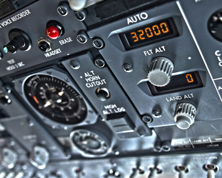 Close-up of aircraft cockpit controls with altitude and cockpit voice recorder indicators.